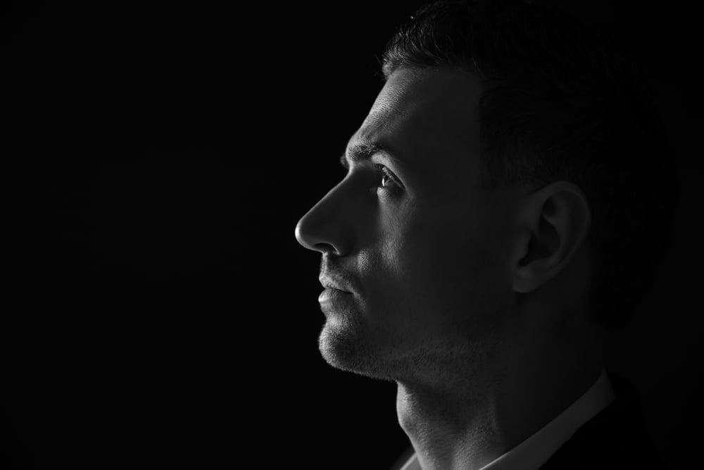 Closeup portrait of a thoughtful man. Black and white photo.