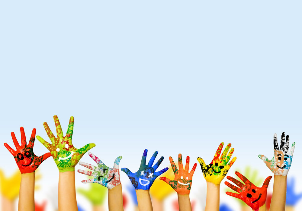 Image of human hands in colorful paint with smiles